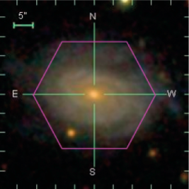 A galaxy inside a pink hexagon, which shows the coverage area of a MaNGA IFU