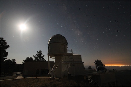 
APOGEE observes a few hundred stars towards the Galactic bulge with the 2.5-meter Sloan Telescope during the full moon. The 1-meter NMSU telescope is in the foreground, with the lights of El Paso on the horizon. 
Image Credit: S. R. Majewski
