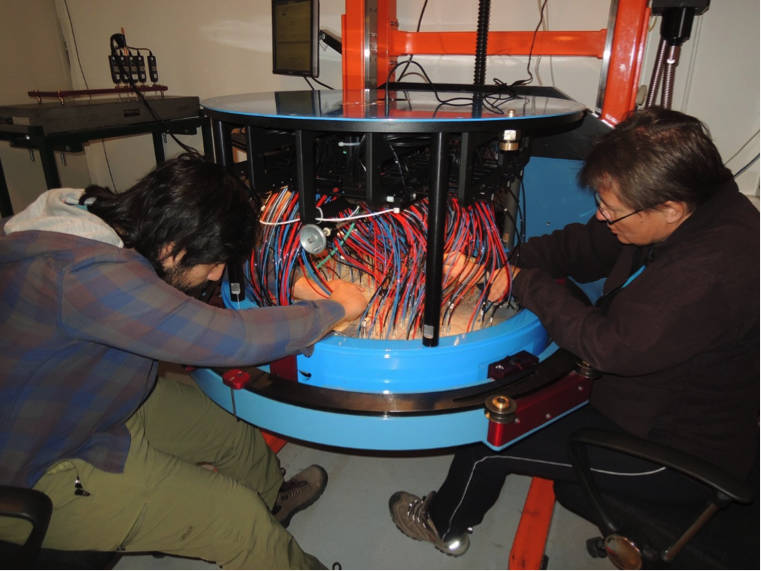 Unlike operations in the North, the observing staff alternate roles between observing and plugging because plates are plugged during the night. Nicolas Medina (left) and Maren Hempel (right) plug an Apogee-South plate. <em>Photo courtesy of J. Wilson.</em>