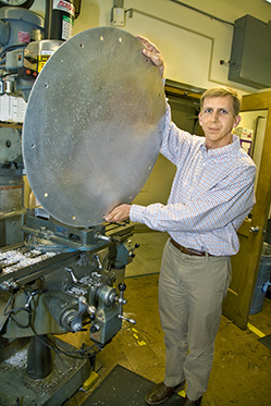 A man holds up an SDSS plate