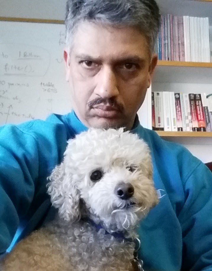 Ani Thakar in his office, holding a small white dog