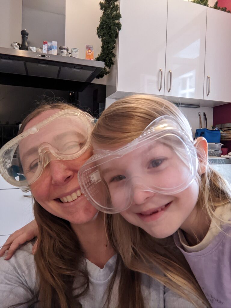 Kathryn Kreckel and a girl child wearing lab goggles