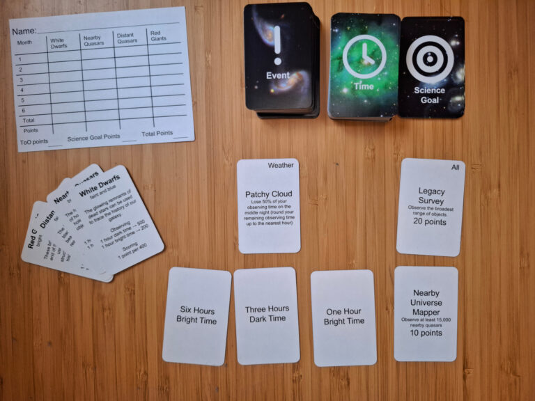 Three decks of cards marked event, time and science goal along with scoresheets